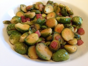 Obsessed Ruth's Brussels Sprouts: Trim & halve 2 lbs. of sprouts. In a large bowl, toss sprouts with 2T olive oil, 2T maple syrup, 3 slices of bacon cut into 1/2 in. pieces, and sea salt/ground pepper (to taste). Roast @ 400 degrees for 30 min., turning every 10 minutes or so, until sprouts are tender & caramelized, and bacon is crisply golden. Yum!